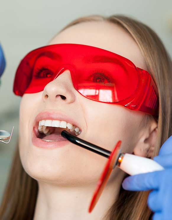 a girl wearing laser safety glasses being treated with solea laser at smith dentalworks