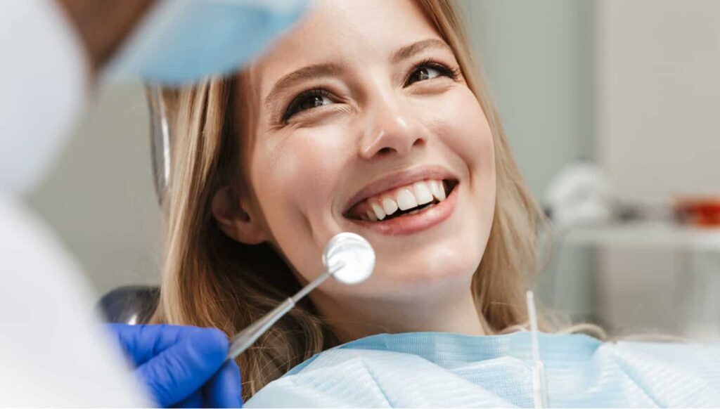 a woman smiling at her dentist appointment at smith dentalworks