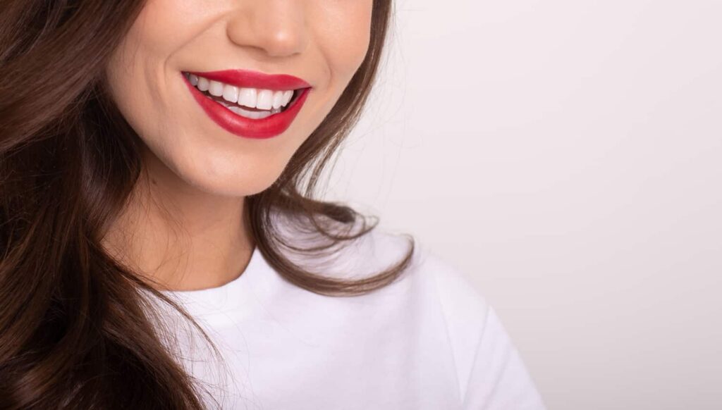 a woman smiling after finding the best teeth whitening method at smith dentalworks
