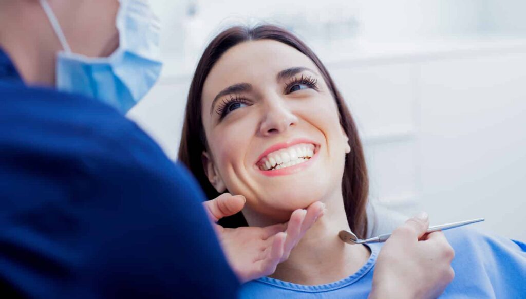 Smiling patient receiving gentle dental care from a professional, highlighting pain-free dentistry at Smith Dentalworks.