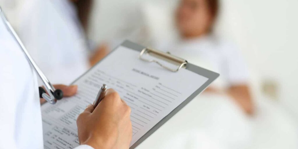 Doctor reviewing patient information sheet for sleep apnea diagnosis in a clinical setting.