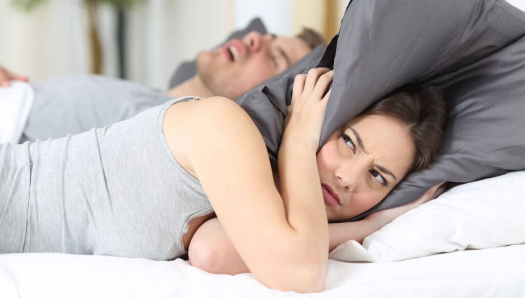 a man with sleep apnea risk factors disturbing his wife need a treatment at smith dentalworks