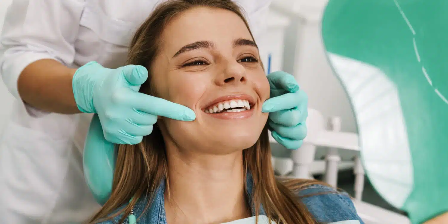 Smiling woman receiving dental care, showcasing comprehensive dental services at Smith Dentalworks clinic.